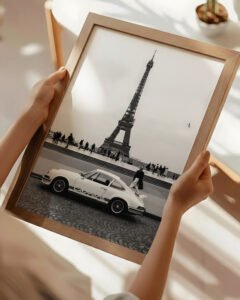 A refined black and white Porsche 911 wall art print set in Paris with the Eiffel Tower. Museum-quality matte finish designed for elevated, modern interiors.