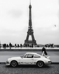 A refined black and white Porsche 911 wall art print set in Paris with the Eiffel Tower. Museum-quality matte finish designed for elevated, modern interiors.