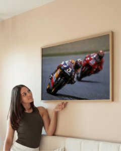Vintage motorcycle racing poster of 1990s rider leaning into apex