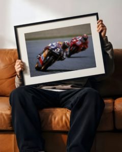 Vintage motorcycle racing poster of 1990s rider leaning into apex