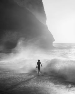 woman running along coast poster for living room, surf-inspired wall art for office, black and white coastal poster