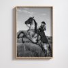 Black and white portrait of a cowgirl riding a horse