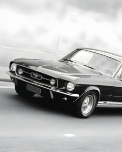 Black-and-white archival print of a 1967 Mustang, cinematic fine art photography capturing sleek lines, motion, and nostalgia.