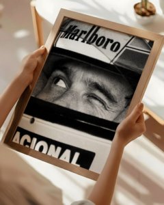 A curated gallery wall featuring the Ayrton Senna F1 print alongside other luxury minimalist wall art in a bright living room.