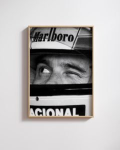 A high-resolution portrait of Ayrton Senna in Formula 1 racing gear, printed on a luxury matte wall art poster by Montclair Collective.