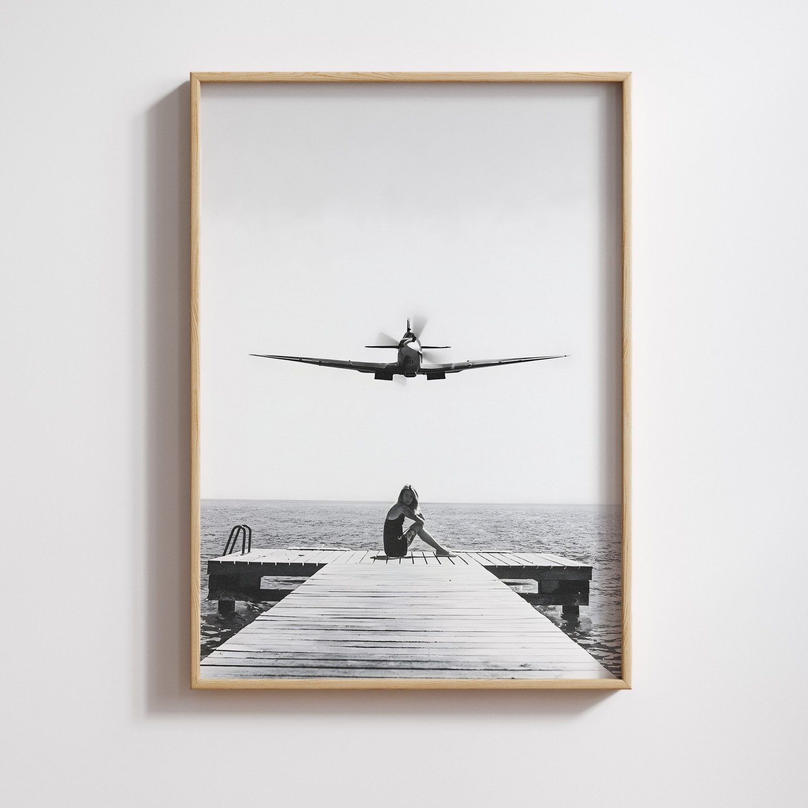 Woman sitting on a dock with a vintage Spitfire flying overhead, cinematic fine art photography.