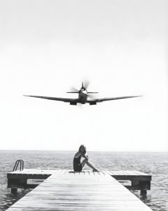 Woman sitting on a dock with a vintage Spitfire flying overhead, cinematic fine art photography.