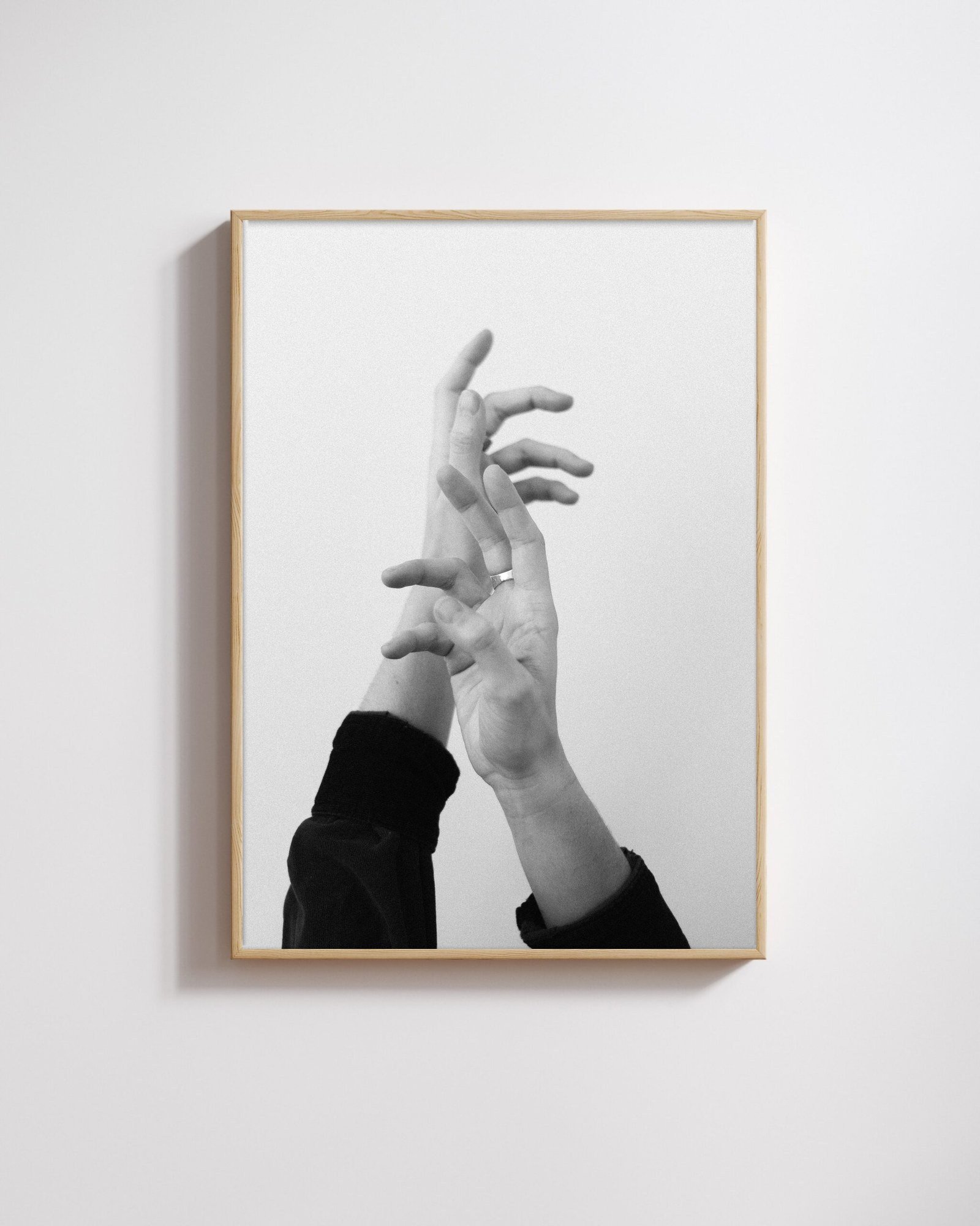 Hands by Shazard R., shown framed in natural oak on a white wall