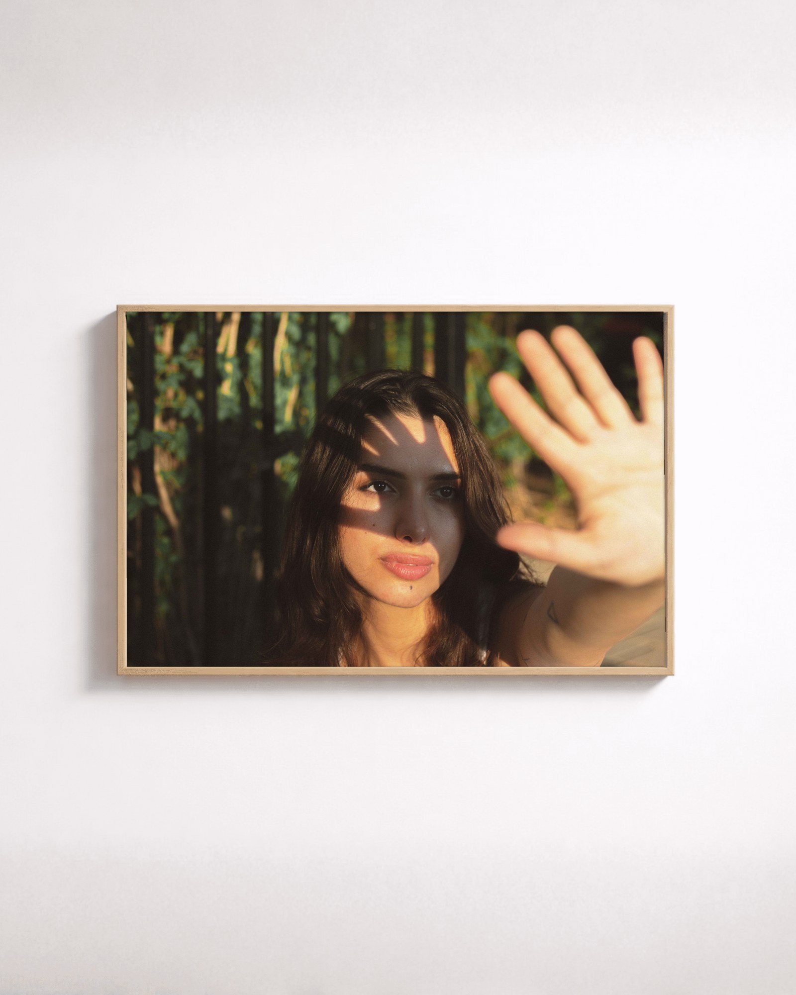 Late Light by Shazard R., shown framed in natural oak on a white wall