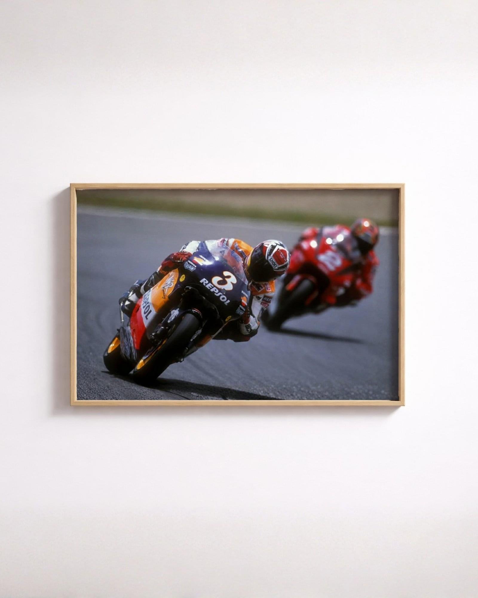 Vintage motorcycle racing poster of 1990s rider leaning into apex